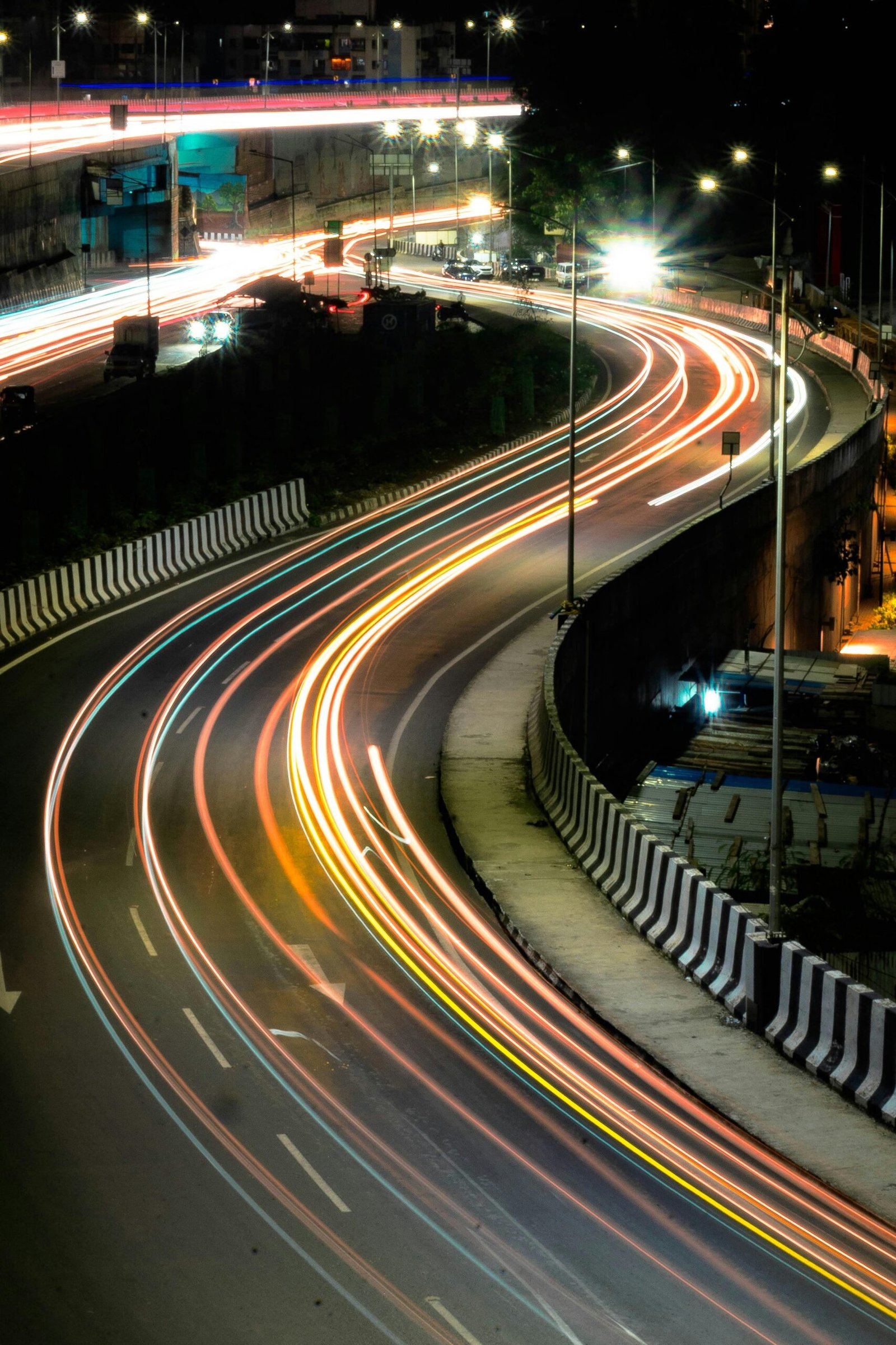 Captivating night shot of Pune's busy roads with dynamic light trails, illustrating urban movement.